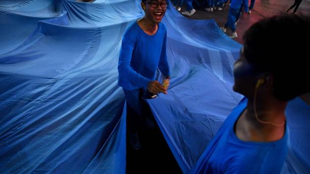 Performers wait to get on stage during the opening ceremony. (AFP) Performers wait to get on stage during the opening ceremony. (AFP)