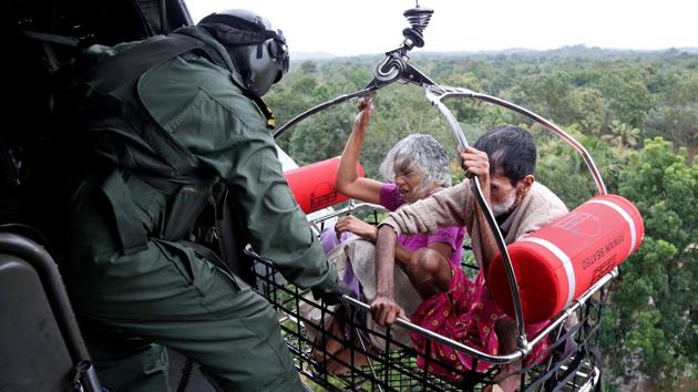People are airlifted by the Indian Navy soldiers during a rescue operation at a flooded area in Kerala. (Sivaram / REUTERS) 