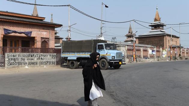 A Kashmiri woman walks in front of the Jamia Masjid grand mosque on the second day of strikes called by Kashmiri separatists in downtown Srinagar on August 6, 2018.(AFP File Photo)