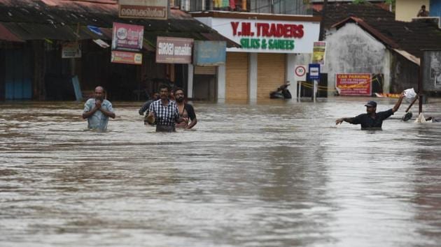 People wade through the flood waters to their marooned houses at Panadala, in district Pathanamthitta of Kerala on August 18. (Raj K Raj/HT PHOTO) People wade through the flood waters to their marooned houses at Panadala, in district Pathanamthitta of Kerala on August 18. (Raj K Raj/HT PHOTO)