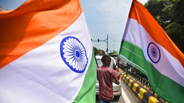 A boy carries the national flag to be sold on the occasion of Independence Day at Shivaji Stadium in New Delhi. (Raj K Raj / HT Photo) 