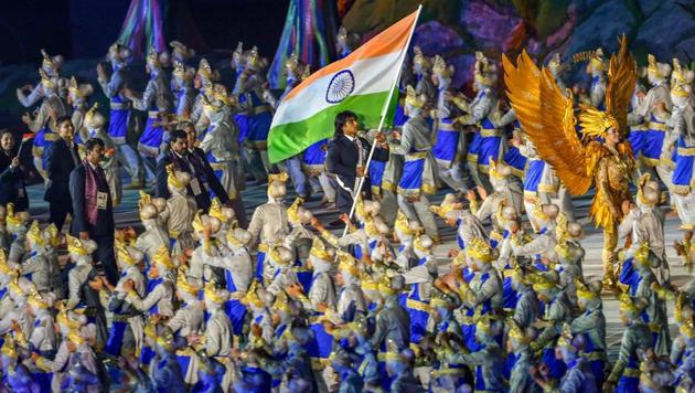 Star javelin thrower Neeraj Chopra bears the tricolour as he leads the Indian contingent at Gelora Bung Karno during the opening ceremony of Asian Games 2018, in Jakarta on Saturday, August 18, 2018.(PTI)