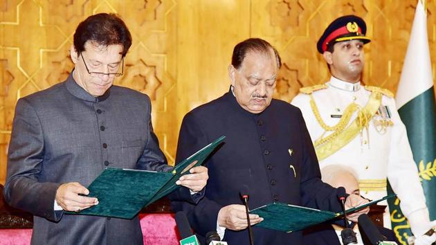 In this handout photograph released by Pakistan's Press Information Department (PID) on August 18, 2018, President of Pakistan Mamnoon Hussain (centre) takes an oath from newly-appointed Prime Minister Imran Khan (left) during a ceremony in Islamabad. (AFP Photo) In this handout photograph released by Pakistan's Press Information Department (PID) on August 18, 2018, President of Pakistan Mamnoon Hussain (centre) takes an oath from newly-appointed Prime Minister Imran Khan (left) during a ceremony in Islamabad. (AFP Photo)