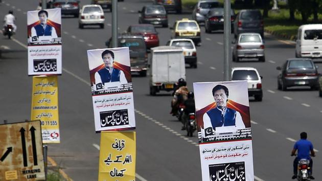 The posters of Pakistan prime minister Imran Khan are displayed along a highway in Islamabad on Saturday. Pakistan's cricket star-turned-politician Khan was sworn in as prime minister on Saturday.(AP)