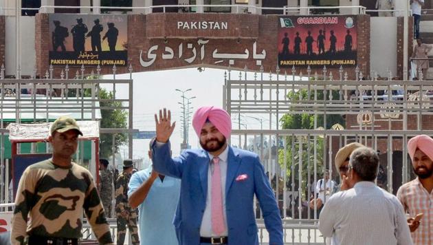 Punjab minister and former cricketer Navjot Singh Sidhu waves as he crosses the border to attend the swearing-in ceremony of Imran Khan, at Attari-Wagah border in Attari. (PTI Photo) Punjab minister and former cricketer Navjot Singh Sidhu waves as he crosses the border to attend the swearing-in ceremony of Imran Khan, at Attari-Wagah border in Attari. (PTI Photo)