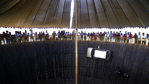 People watch a 'Wall of Death' show at a fair in the outskirts of Ajmer, Rajasthan. (Himanshu Sharma / AFP) 