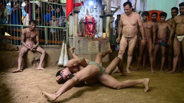 Wrestlers take part in a bout of traditional wrestling at the Loknath Vyayamsala wrestling club to mark the Nag Panchami festival in Allahabad, Uttar Pradesh. (Sanjay Kanojia / AFP) 