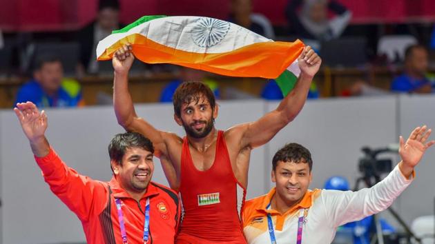 India's Bajrang Punia carries the tricolour after winning in the Finals of men's freestyle wrestling (65kg) against Japan's Daichi Takatani at the Asian Games 2018, in Jakarta on Sunday, August 19, 2018.(PTI)