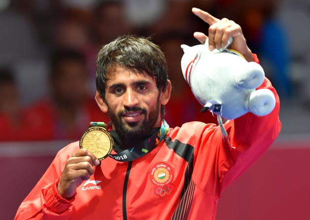 Jakarta: India's Bajrang Punia poses with his gold medal after winning in the Finals of men's freestyle wrestling (65kg) against Japan's Daichi Takatani at the Asian Games 2018, in Jakarta on Sunday, August 19, 2018. (PTI Photo/Shahbaz Khan) (PTI8_19_2018_000227B) (PTI)
