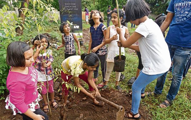 Residents of Crystal Castle society during the tree plantation drive on Sunday. (Pratham Gokhale/HT Photo) Residents of Crystal Castle society during the tree plantation drive on Sunday. (Pratham Gokhale/HT Photo)
