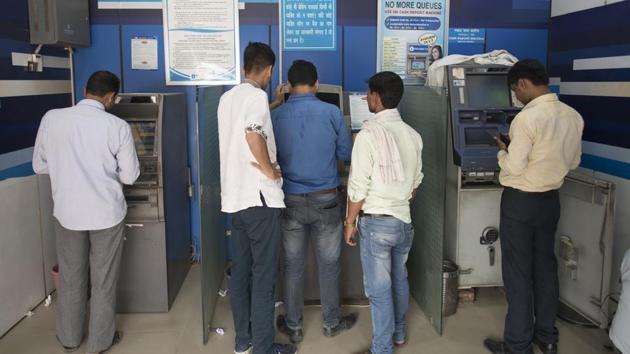 People withdraw cash from an ATM at Chandni Chowk in New Delhi. The government notification said during the refilling of ATMs, agencies must provide private security for the cash transportation with the requisite number of trained staff. Every cash van will have one driver, two armed security guards, two ATM officers or custodians. (Sanchit Khanna/HT Photo) People withdraw cash from an ATM at Chandni Chowk in New Delhi. The government notification said during the refilling of ATMs, agencies must provide private security for the cash transportation with the requisite number of trained staff. Every cash van will have one driver, two armed security guards, two ATM officers or custodians. (Sanchit Khanna/HT Photo)