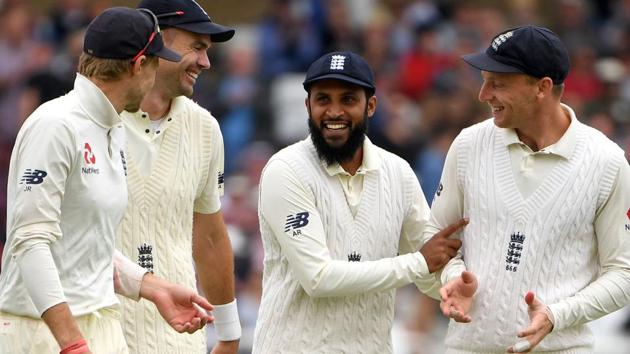 England's Adil Rashid (C) smiles as he celebrates catching out India's Cheteshwar Pujara during play on the first day. (AFP)