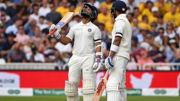 India's Ajinkya Rahane (L) celebrates reaching his half century during play on the first day. (AFP)