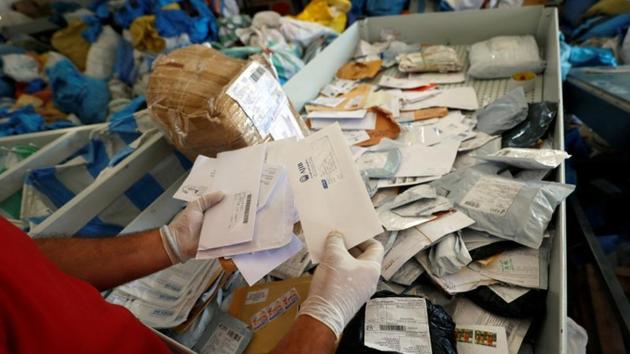 A Palestinian worker displays items sent by mail eight years ago as they reach destination, after Israel allowed the letters and goods into the West Bank from Jordan, where they were being held, Jericho, in the occupied West Bank on August 19.(REUTERS) A Palestinian worker displays items sent by mail eight years ago as they reach destination, after Israel allowed the letters and goods into the West Bank from Jordan, where they were being held, Jericho, in the occupied West Bank on August 19.(REUTERS)