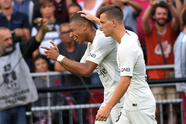 French forward Kylian Mbappe (L) celebrates with Paris Saint-Germain's Argentine midfielder Giovani Lo Celso after scoring during the French L1 football match between Guingamp and Paris Saint-Germain.(AFP)