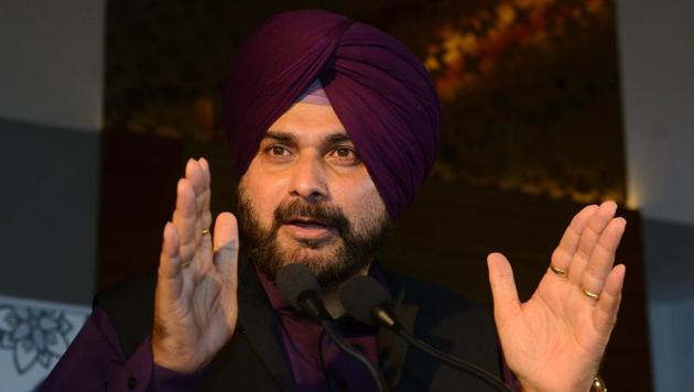 Punjab Cabinet Minister Navjot Singh Sidhu sparked major controversy after being shown seated next to the president of Pakistan Occupied Kashmir (PoK) at Pakistan Prime Minister Imran Khan’s swearing-in and hugging Pakistan army chief Gen Qamar Javed Bajwa.(AFP)