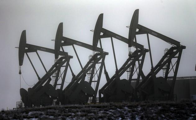 Oil pump jacks work in unison in Williston. (AP File Photo) Oil pump jacks work in unison in Williston. (AP File Photo)