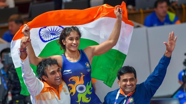 India's Vinesh Phogat celebrates with the Tricolour after winning the Gold medal in women's freestyle 50 kg wrestling at the Asian Games 2018, in Jakarta on Monday, August 20, 2018. Phogat made history after she became the first Indian woman to win a gold at Asian Games. She beat Japan’s Irie Yukie 6-2 in the finals. (PTI) India's Vinesh Phogat celebrates with the Tricolour after winning the Gold medal in women's freestyle 50 kg wrestling at the Asian Games 2018, in Jakarta on Monday, August 20, 2018. Phogat made history after she became the first Indian woman to win a gold at Asian Games. She beat Japan’s Irie Yukie 6-2 in the finals. (PTI)