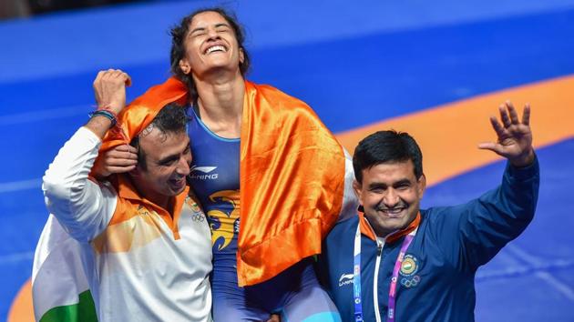 Jakarta: India's Vinesh Phogat celebrates after winning the Gold medal in women's freestyle 50 kg wrestling at the Asian Games 2018, in Jakarta on Monday, August 20, 2018. Phogat made the history after she became the first Indian woman to win a gold at Asian Games. She beat Japan’s Irie Yukie 6-2 in the finals.(PTI)