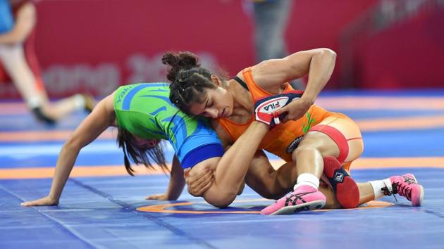 Vinesh Phogat of India (in orange) grapples Uzbekistan's D Yakhshimuratova in the semi-finals of women’s 50kg freestyle wrestling event at Asian Games 2018, in Jakarta. Phogat won her bout in little over a minute to storm into the title round, beating Yakhshimuratova by technical superiority. (Shahbaz Khan / PTI) Vinesh Phogat of India (in orange) grapples Uzbekistan's D Yakhshimuratova in the semi-finals of women’s 50kg freestyle wrestling event at Asian Games 2018, in Jakarta. Phogat won her bout in little over a minute to storm into the title round, beating Yakhshimuratova by technical superiority. (Shahbaz Khan / PTI)