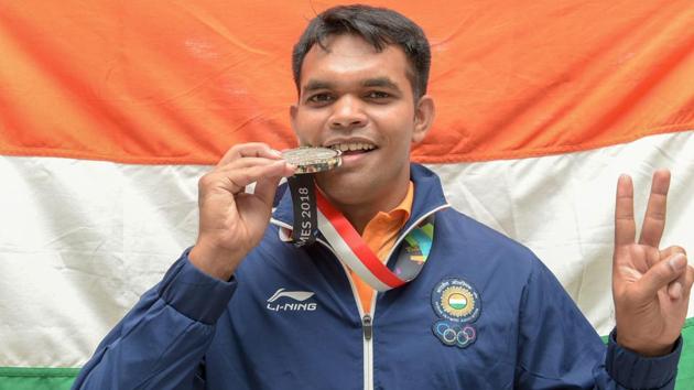 Palembang: Indian shooter Deepak Kumar poses with his silver medal after the medal ceremony for the Final10m Air Rifle Men's event. (PTI) Palembang: Indian shooter Deepak Kumar poses with his silver medal after the medal ceremony for the Final10m Air Rifle Men's event. (PTI)