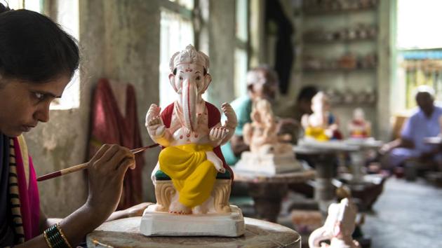 A worker at the workshop adds finishing touches to an idol. Pandurang Hazare admits that his workshop keeps receiving requests for idols made of PoP but has consistently refused to accept them all these years over deeply ingrained environmental concerns. (Satish Bate / HT Photo) A worker at the workshop adds finishing touches to an idol. Pandurang Hazare admits that his workshop keeps receiving requests for idols made of PoP but has consistently refused to accept them all these years over deeply ingrained environmental concerns. (Satish Bate / HT Photo)