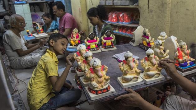 Hazare fell into this business following in the footsteps of his father. With the entry of the family’s youngest, a 10-year-old who’s now helping out, this eco-friendly idol making workshop has added to its generations strong legacy. (Satish Bate / HT Photo) 
