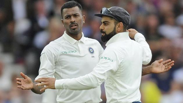 Indian cricket captain Virat Kohli, right, congratulates teammate Hardik Pandya for the dismissal of England's Adil Rashid.(AP)