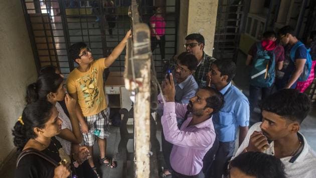 Students and parents check the first merit list of FYJC at Ruia college, Matunga in Mumbai, India. (HT File Photo) Students and parents check the first merit list of FYJC at Ruia college, Matunga in Mumbai, India. (HT File Photo)