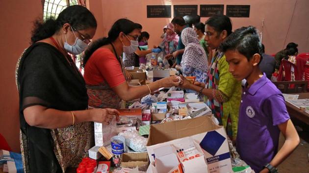 Flood-affected people receive free medicines inside a college, which has been converted into a temporary relief camp, in Aluva. As water recedes, snakes and snails found floating in many homes. Some incidents of snake-bites have also been reported in Paravur. (Sivaram V / REUTERS) Flood-affected people receive free medicines inside a college, which has been converted into a temporary relief camp, in Aluva. As water recedes, snakes and snails found floating in many homes. Some incidents of snake-bites have also been reported in Paravur. (Sivaram V / REUTERS)