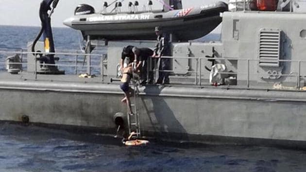 In this photo provided by the Croatian Defence Ministry, a woman who identified herself as Kay from England, climbs aboard a Croatian Coast Guard ship some 90 kilometres from the Croatian coast.(AP Photo)