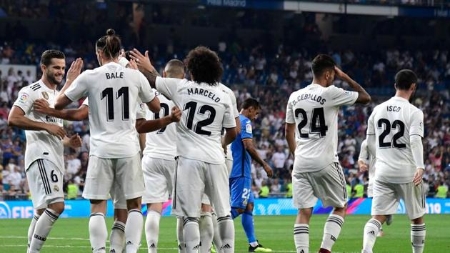 Real Madrid's Welsh forward Gareth Bale (2ndL) celebrates with teammates after scoring a goal during the Spanish League football match between Real Madrid and Getafe.(AFP)