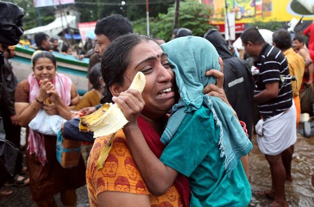 A woman cries as she holds her son after they were evacuated from a flooded area in Aluva, Kerala, on August 18, 2018. As of Tuesday there are a total of 10,28,073 people in 5,645 relief camps across the state of Kerala since the start of the rains. As rains and floodwaters begin receding from many areas in Kerala, rescue operations are scaling down and said to be in their final stages. (Sivaram V / REUTERS) A woman cries as she holds her son after they were evacuated from a flooded area in Aluva, Kerala, on August 18, 2018. As of Tuesday there are a total of 10,28,073 people in 5,645 relief camps across the state of Kerala since the start of the rains. As rains and floodwaters begin receding from many areas in Kerala, rescue operations are scaling down and said to be in their final stages. (Sivaram V / REUTERS)