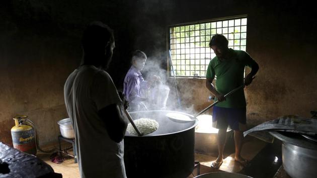 Volunteers cook food for flood effected people at a relief camp set up inside a government run school in Alappuzha on August 20, 2018. The government will start the process to accurately assess the damage after the relief and rescue work is over. (Aijaz Rahi / AP) Volunteers cook food for flood effected people at a relief camp set up inside a government run school in Alappuzha on August 20, 2018. The government will start the process to accurately assess the damage after the relief and rescue work is over. (Aijaz Rahi / AP)