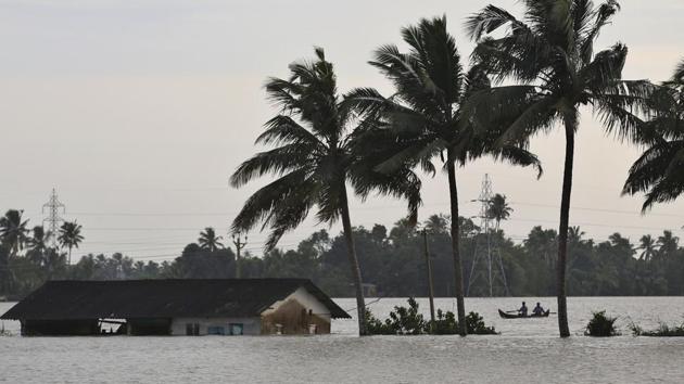 Two men row a boat through a flooded paddy field next to an inundated structure in Alappuzha, Kerala. (AP Photo) Two men row a boat through a flooded paddy field next to an inundated structure in Alappuzha, Kerala. (AP Photo)