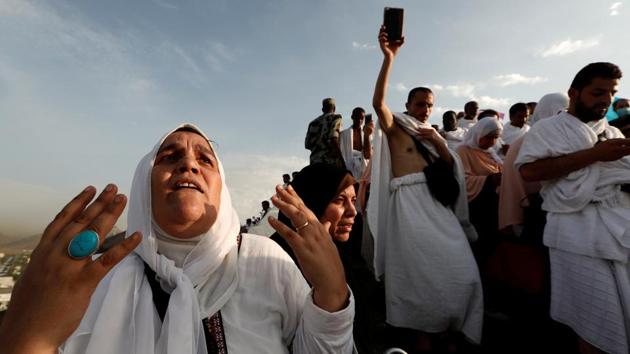 A Muslim pilgrim prays as she gather with others on Mount Mercy (Jabal ar-Rahmah) on the plains of Arafat during the annual Hajj pilgrimage on August 20, 2018. Muslims believe prayer on Mount Arafat, about 20 kilometers east of the holy city of Mecca, is their best chance to erase past sins and start anew. (Zohra Bensemra / REUTERS)