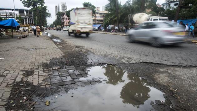 Potholes near Mahim station in Mumbai on Monday.(Pratik Chorge/HT Photo)