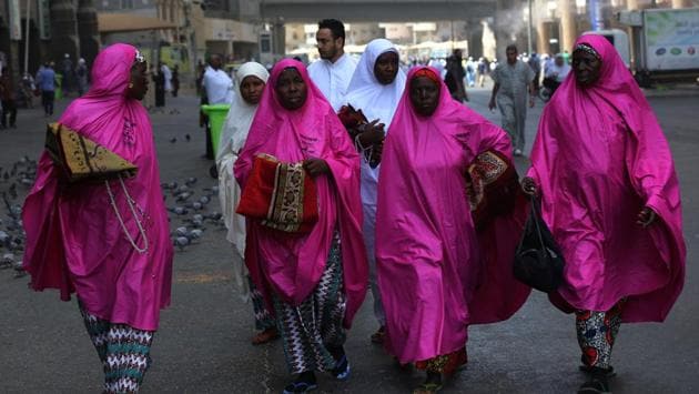 African pilgrims walk outside the Grand Mosque in Mecca, prior to the start of the annual Hajj pilgrimage. The ultra-conservative kingdom -- where religion remains a guiding force amid dramatic social and economic reforms -- has mobilised vast resources for the five-day journey, a pillar of Islam. (Ahmad Al-Rubaye / AFP)