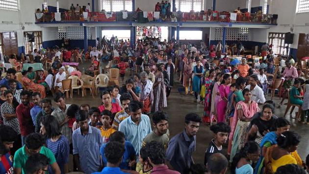 Flood victims wait for food inside a college auditorium, which has been converted into a temporary relief camp, in Kochi, in Kerala.(Reuters photo) Flood victims wait for food inside a college auditorium, which has been converted into a temporary relief camp, in Kochi, in Kerala.(Reuters photo)