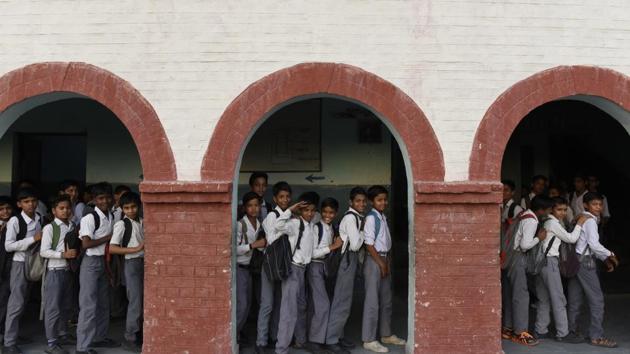 Boys leave for the day at Govt Boys Senior Secondary School in Sangam Vihar.(HT File Photo)