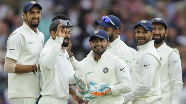 Rishabh Pant, center, stands with captain Virat Kohli, second left, and teammates as they celebrate the dismissal of Adil Rashid.(AP)