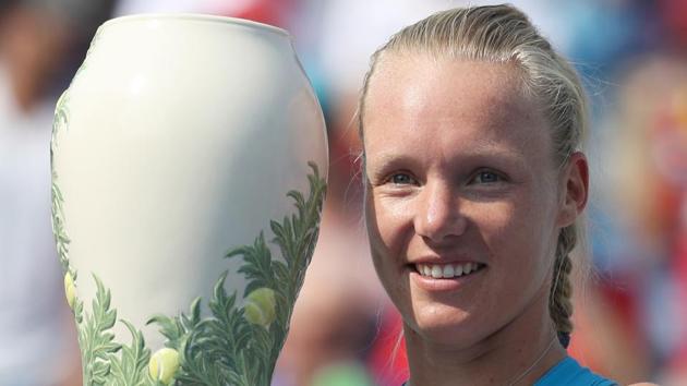 Kiki Bertens of the Netherlands holds the trophy after defeating Simona Halep of Romania during the women’s final.(AFP)