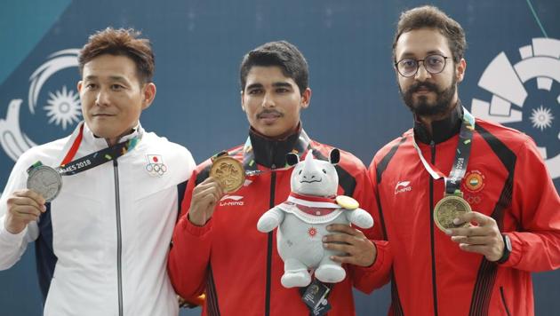 Saurabh Chaudhary (C) on Tuesday became only the fifth Indian shooter to claim a gold in the Asian Games history, beating a field of multiple world and Olympic champions in the 10m air pistol finals in Palembang, Indonesia.(AP)