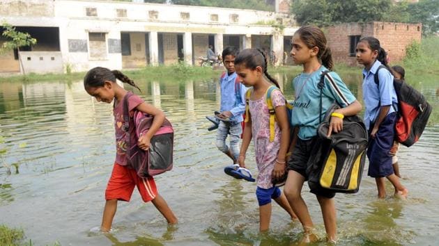 Children walking through a ground inundated with overflow from a septic tank to reach Government Elementary School on the outskirts of Kalar Bheni village, 12km from Patiala, on Tuesday. This has been their routine for the past one month. (Bharat Bhushan/HT) Children walking through a ground inundated with overflow from a septic tank to reach Government Elementary School on the outskirts of Kalar Bheni village, 12km from Patiala, on Tuesday. This has been their routine for the past one month. (Bharat Bhushan/HT)