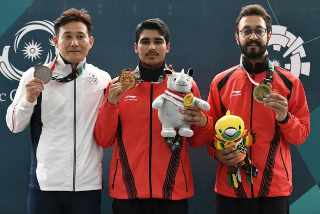 From L to R: Silver medallist Japan's Tomoyuki Matsuda, gold medallist India's Saurabh Chaudhary and bronze medallist India's Abhishek Verma pose with their medals during their victory ceremony for the 10m air pistol men shooting final during the 2018 Asian Games in Palembang on August 21, 2018. (Photo by Mohd RASFAN / AFP) (AFP) From L to R: Silver medallist Japan's Tomoyuki Matsuda, gold medallist India's Saurabh Chaudhary and bronze medallist India's Abhishek Verma pose with their medals during their victory ceremony for the 10m air pistol men shooting final during the 2018 Asian Games in Palembang on August 21, 2018. (Photo by Mohd RASFAN / AFP) (AFP)