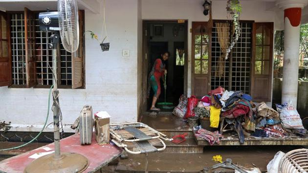 A woman clears mud from the entrance of her house following floods in Paravur, Kerala. The government estimates about one lakh buildings, which includes people’s houses, have been damaged, over 10,000km of highways and roads and hundreds of bridges have been washed away, and crops on millions of hectares of land have been lost in the Kerala floods. (Sivaram V / REUTERS) A woman clears mud from the entrance of her house following floods in Paravur, Kerala. The government estimates about one lakh buildings, which includes people’s houses, have been damaged, over 10,000km of highways and roads and hundreds of bridges have been washed away, and crops on millions of hectares of land have been lost in the Kerala floods. (Sivaram V / REUTERS)