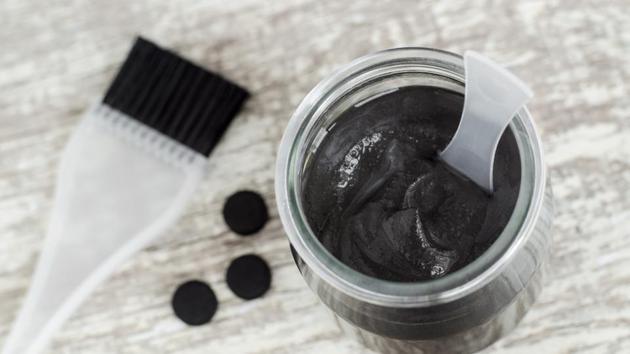 The charcoal used in these masks is activated charcoal. Activated charcoal has a unique ability to bind toxins, oxidised impurities and blackheads and sucks them out of our face.(Getty Images/iStockphoto)