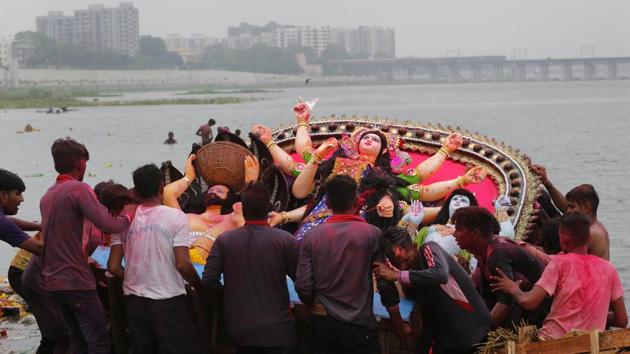 Devotees immerse an idol of Hindu goddess Dashama on the bank of the river Sabarmati at the end of Dashama festival in Ahmedabad. The ten-day festival celebrated in the Shravan month of the Hindu calendar culminates with the immersion of the idols of the deity who is worshipped in the western state of Gujarat for good health and prosperity. (Ajit Solanki / AP) Devotees immerse an idol of Hindu goddess Dashama on the bank of the river Sabarmati at the end of Dashama festival in Ahmedabad. The ten-day festival celebrated in the Shravan month of the Hindu calendar culminates with the immersion of the idols of the deity who is worshipped in the western state of Gujarat for good health and prosperity. (Ajit Solanki / AP)