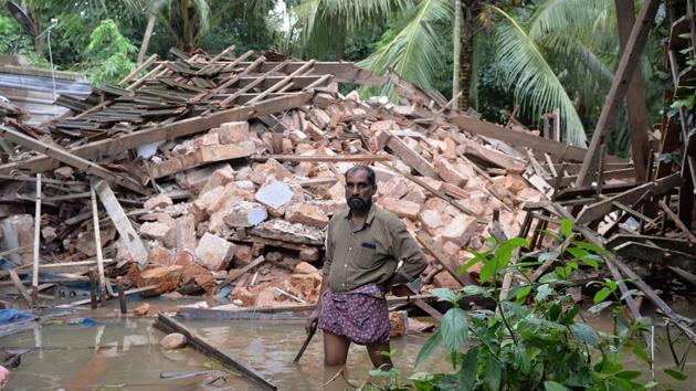 Ajith Prasad (54) stands in front of the rubble of his house on the outskirts of Kozhikode district of Kerala on August 17, 2018. The government estimates about one lakh buildings, which includes people’s houses, have been damaged. Over 10,000km of highways and roads and hundreds of bridges have been washed away. (Manjunath Kiran / AFP) Ajith Prasad (54) stands in front of the rubble of his house on the outskirts of Kozhikode district of Kerala on August 17, 2018. The government estimates about one lakh buildings, which includes people’s houses, have been damaged. Over 10,000km of highways and roads and hundreds of bridges have been washed away. (Manjunath Kiran / AFP)