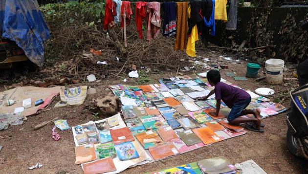 A student dries out his school books after flooding hit his home in Kochi on August 21. (AFP Photo) A student dries out his school books after flooding hit his home in Kochi on August 21. (AFP Photo)